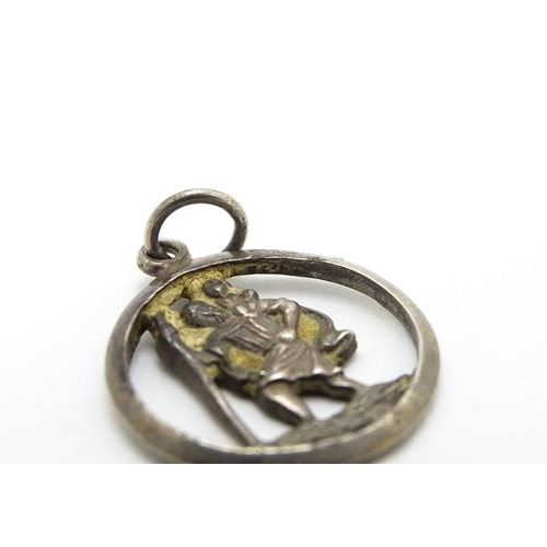 788 - A Continental silver pendant depicting St Christopher. Together with another. Largest approx. 1