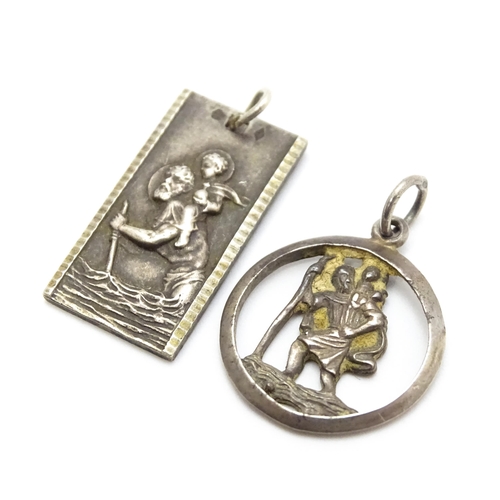 788 - A Continental silver pendant depicting St Christopher. Together with another. Largest approx. 1