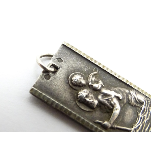 788 - A Continental silver pendant depicting St Christopher. Together with another. Largest approx. 1