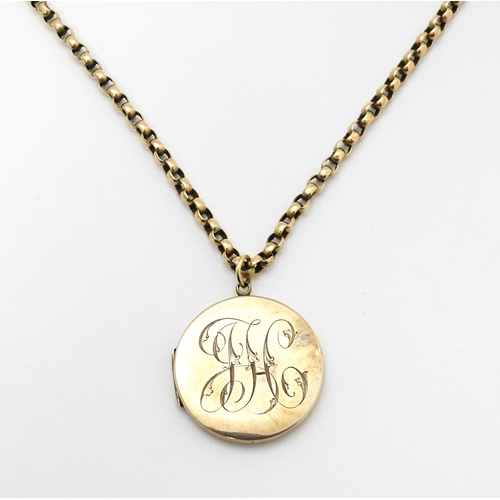 789 - A 9ct gold and yellow metal chain set with circular yellow metal pendant locket. Pendant approx. 1 1... 