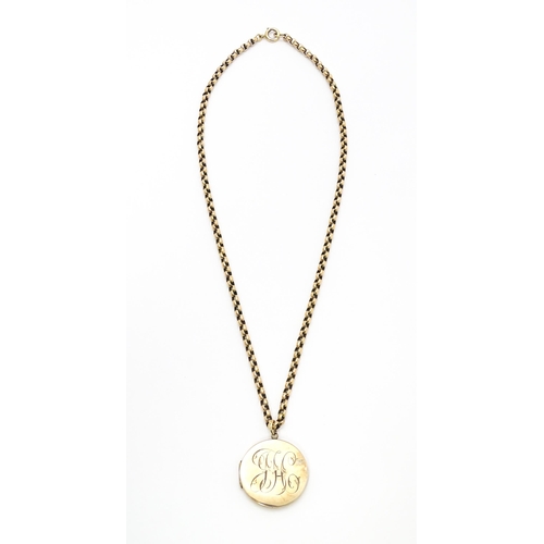 789 - A 9ct gold and yellow metal chain set with circular yellow metal pendant locket. Pendant approx. 1 1... 