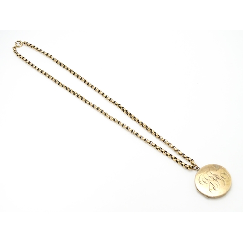 789 - A 9ct gold and yellow metal chain set with circular yellow metal pendant locket. Pendant approx. 1 1... 