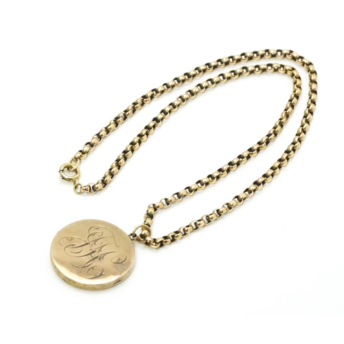 789 - A 9ct gold and yellow metal chain set with circular yellow metal pendant locket. Pendant approx. 1 1... 