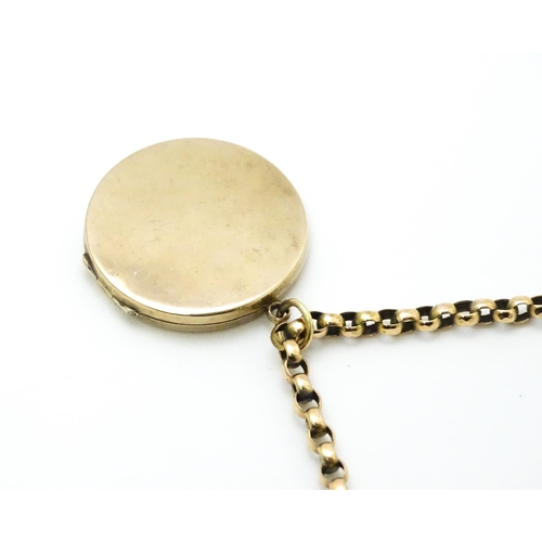 789 - A 9ct gold and yellow metal chain set with circular yellow metal pendant locket. Pendant approx. 1 1... 