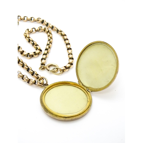 789 - A 9ct gold and yellow metal chain set with circular yellow metal pendant locket. Pendant approx. 1 1... 