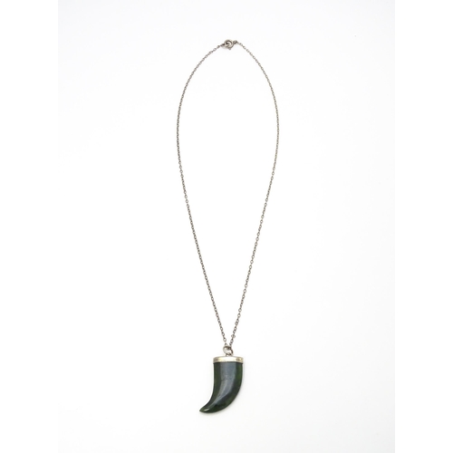 790 - A jade green coloured hardstone pendant with white metal mounts and chain. Pendant approx. 1 3/4