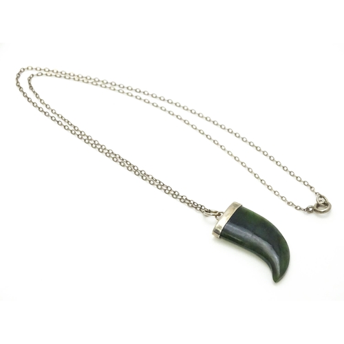 790 - A jade green coloured hardstone pendant with white metal mounts and chain. Pendant approx. 1 3/4