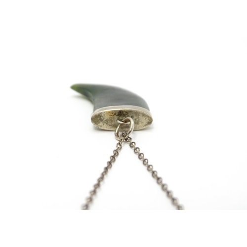 790 - A jade green coloured hardstone pendant with white metal mounts and chain. Pendant approx. 1 3/4