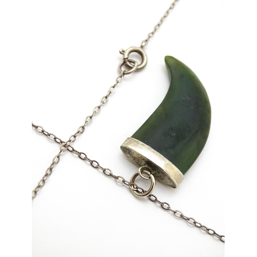 790 - A jade green coloured hardstone pendant with white metal mounts and chain. Pendant approx. 1 3/4