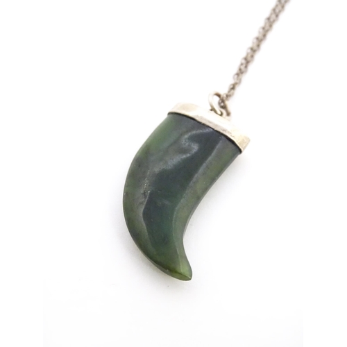 790 - A jade green coloured hardstone pendant with white metal mounts and chain. Pendant approx. 1 3/4