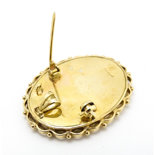 793 - A 9ct gold pendant / brooch with hand painted portrait miniature to centre set with diamonds and sig... 