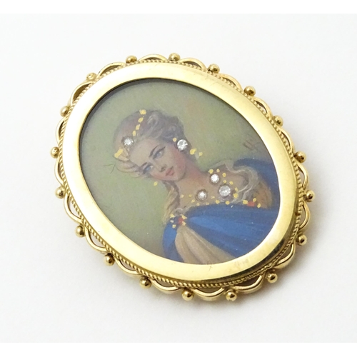 793 - A 9ct gold pendant / brooch with hand painted portrait miniature to centre set with diamonds and sig... 