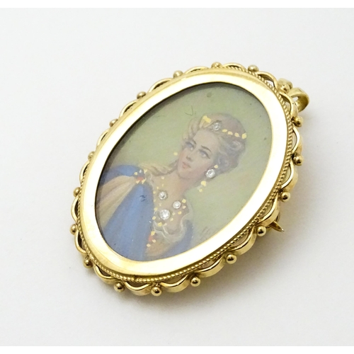 793 - A 9ct gold pendant / brooch with hand painted portrait miniature to centre set with diamonds and sig... 