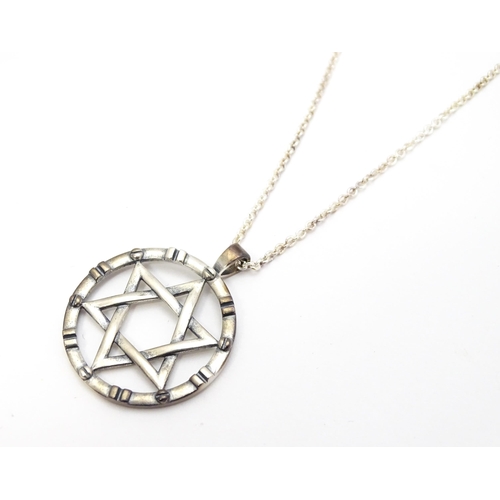 795 - A silver pendant with Star of David detail, on silver chain. Pendant approx. 1 1/4