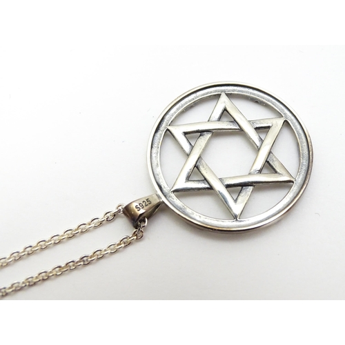 795 - A silver pendant with Star of David detail, on silver chain. Pendant approx. 1 1/4