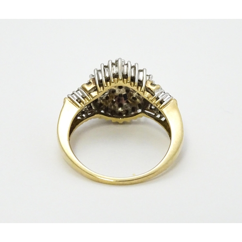 798 - A 9ct gold cocktail ring set with a central cluster of diamonds flanked by further diamonds to shoul... 