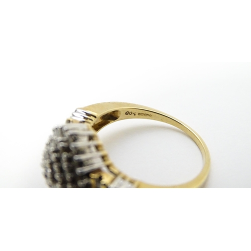 798 - A 9ct gold cocktail ring set with a central cluster of diamonds flanked by further diamonds to shoul... 