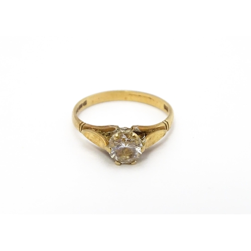 799 - A 9ct gold ring set with white stone solitaire. Ring size approx. N