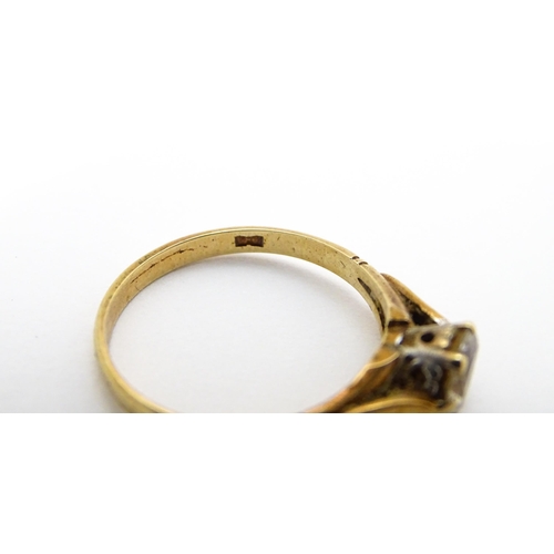 799 - A 9ct gold ring set with white stone solitaire. Ring size approx. N