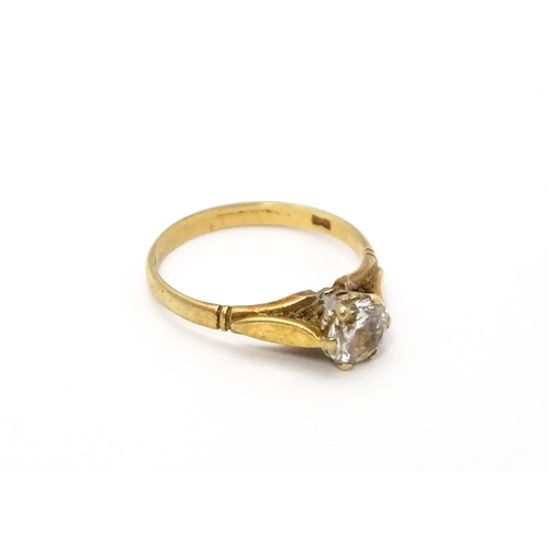 799 - A 9ct gold ring set with white stone solitaire. Ring size approx. N