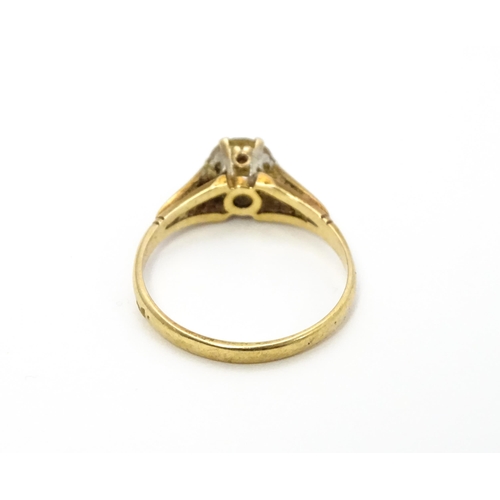 799 - A 9ct gold ring set with white stone solitaire. Ring size approx. N