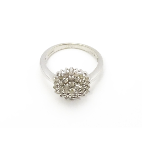 802 - A 9ct white gold ring set with diamond cluster. Ring size approx. R 1/2