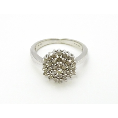 802 - A 9ct white gold ring set with diamond cluster. Ring size approx. R 1/2