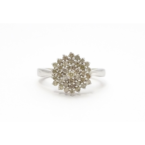 802 - A 9ct white gold ring set with diamond cluster. Ring size approx. R 1/2