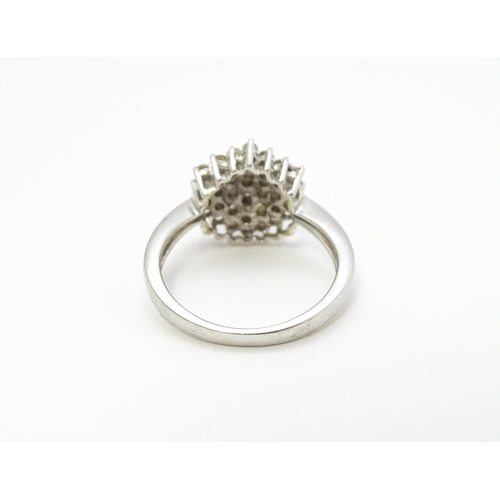 802 - A 9ct white gold ring set with diamond cluster. Ring size approx. R 1/2