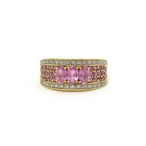 803 - An 18ct gold ring set with pink sapphires and diamonds. Ring size approx. L 1/2