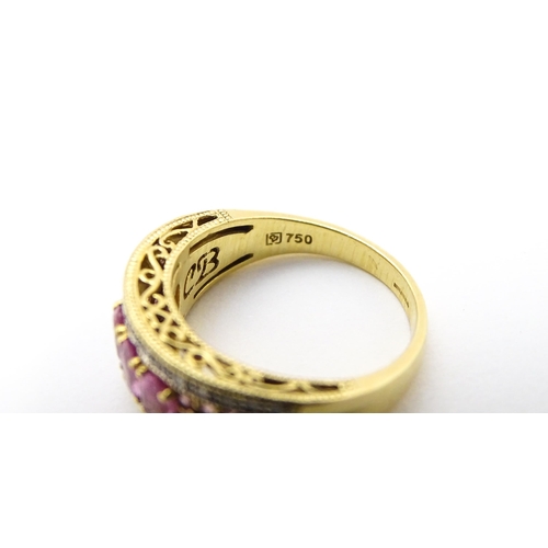 803 - An 18ct gold ring set with pink sapphires and diamonds. Ring size approx. L 1/2