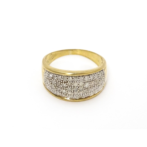 804 - A 9ct gold ring set with a profusion of diamonds. Ring size approx. V 1/2