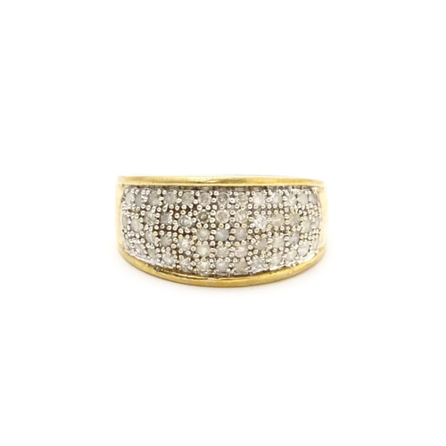 804 - A 9ct gold ring set with a profusion of diamonds. Ring size approx. V 1/2