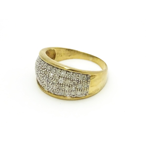 804 - A 9ct gold ring set with a profusion of diamonds. Ring size approx. V 1/2