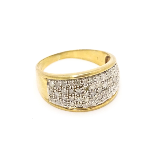 804 - A 9ct gold ring set with a profusion of diamonds. Ring size approx. V 1/2