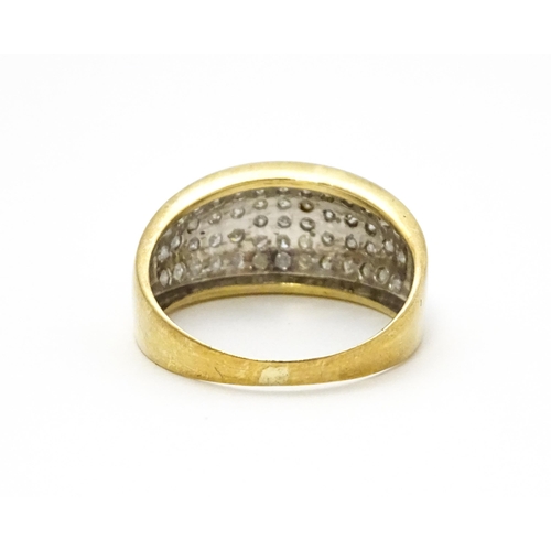 804 - A 9ct gold ring set with a profusion of diamonds. Ring size approx. V 1/2