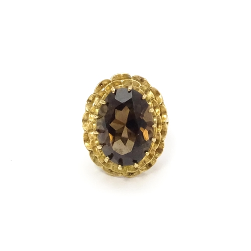 805 - A 9ct gold ring set with central smoky quartz. Ring size approx. P 1/2