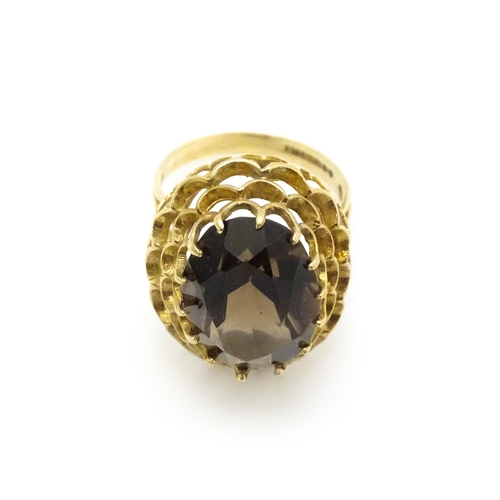 805 - A 9ct gold ring set with central smoky quartz. Ring size approx. P 1/2