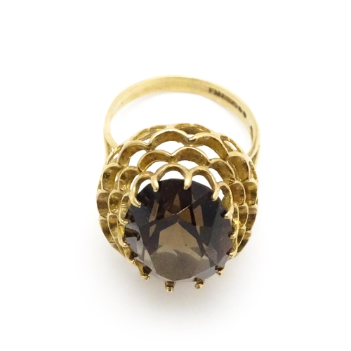 805 - A 9ct gold ring set with central smoky quartz. Ring size approx. P 1/2