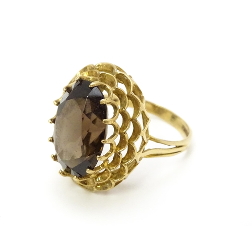 805 - A 9ct gold ring set with central smoky quartz. Ring size approx. P 1/2