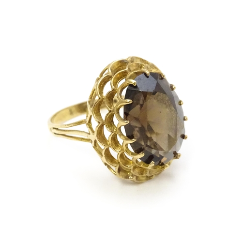 805 - A 9ct gold ring set with central smoky quartz. Ring size approx. P 1/2