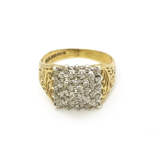 806 - A 9ct gold ring set with a profusion of diamonds in a square setting. Ring size approx. K