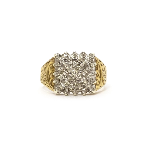 806 - A 9ct gold ring set with a profusion of diamonds in a square setting. Ring size approx. K