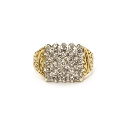 806 - A 9ct gold ring set with a profusion of diamonds in a square setting. Ring size approx. K