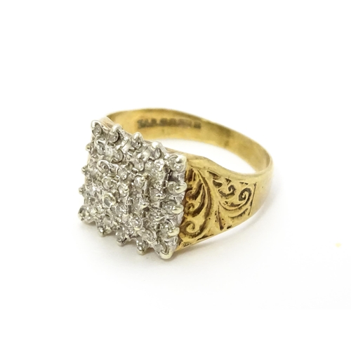 806 - A 9ct gold ring set with a profusion of diamonds in a square setting. Ring size approx. K