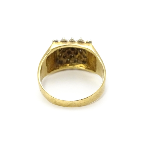 806 - A 9ct gold ring set with a profusion of diamonds in a square setting. Ring size approx. K