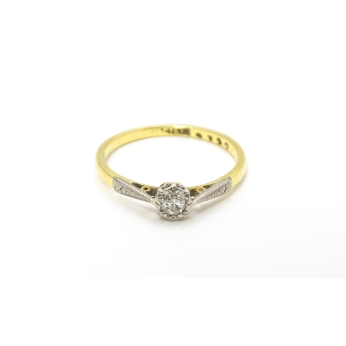 807 - An 18ct gold ring with platinum set diamond solitaire. Ring size approx. M