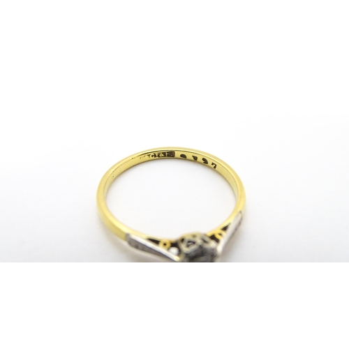 807 - An 18ct gold ring with platinum set diamond solitaire. Ring size approx. M