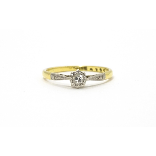 807 - An 18ct gold ring with platinum set diamond solitaire. Ring size approx. M