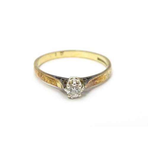 810 - A 9ct gold ring set with diamond solitaire. Ring size approx. L 1/2